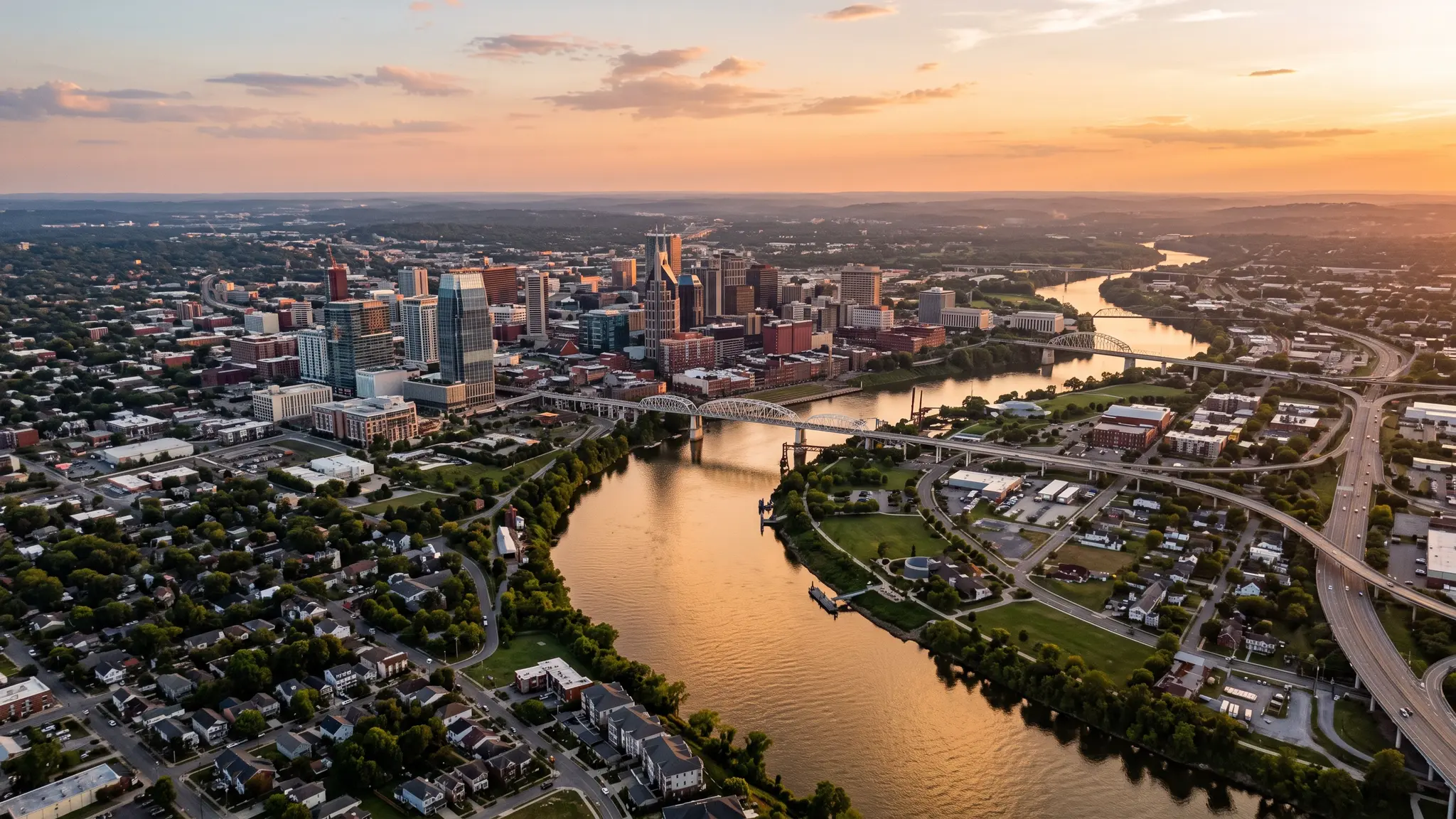 Foundation service areas in Middle Tennessee | Music City Foundation Aerial view of the Cumberland River winding past the Nashville skyline and residential neighborhoods at sunset